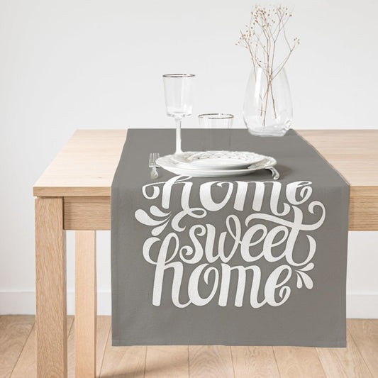 Grey table runner with "Home Sweet Home" embroidery for cozy dining.