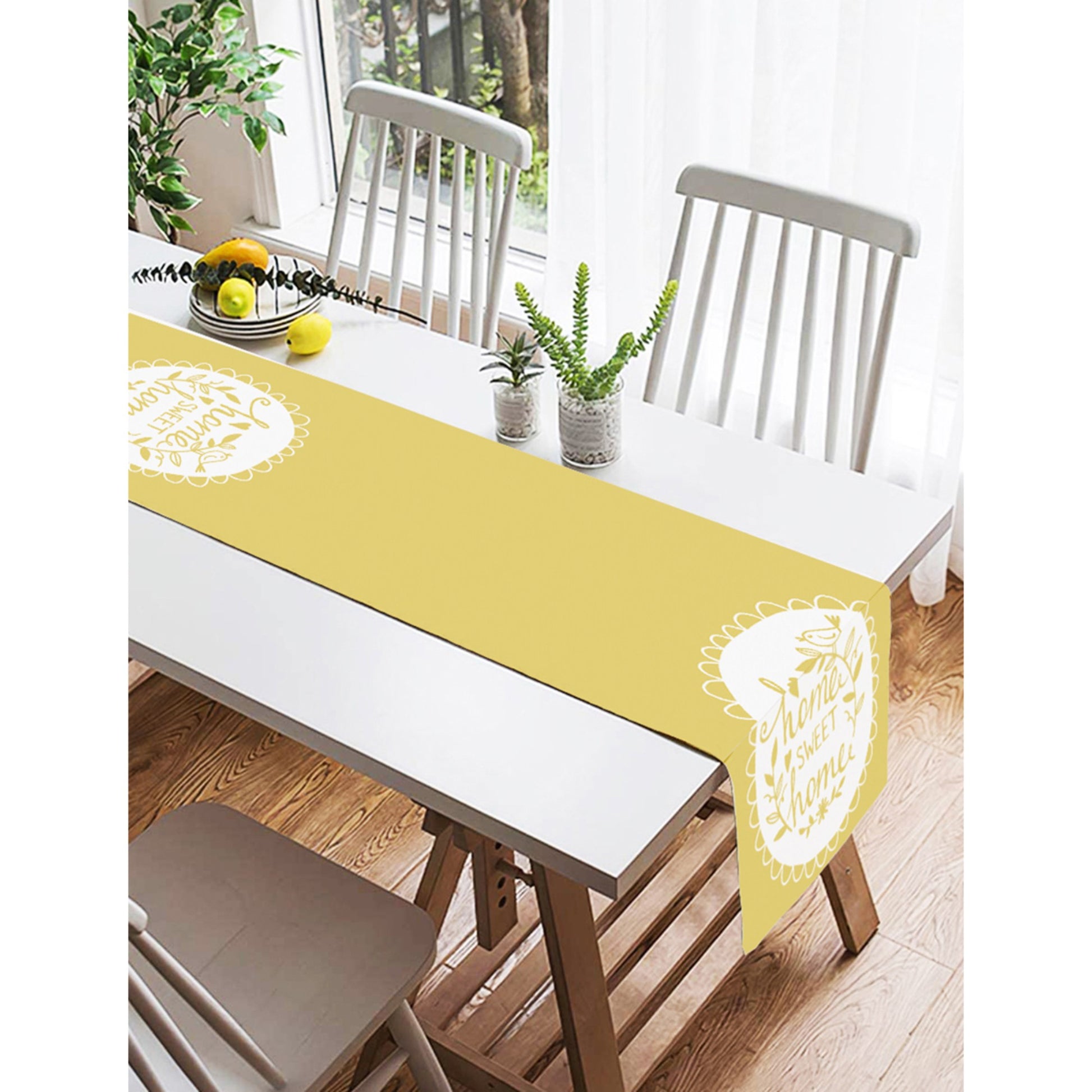 Contemporary table runner in yellow with "Home Sweet Home" embroidery for stylish dining.