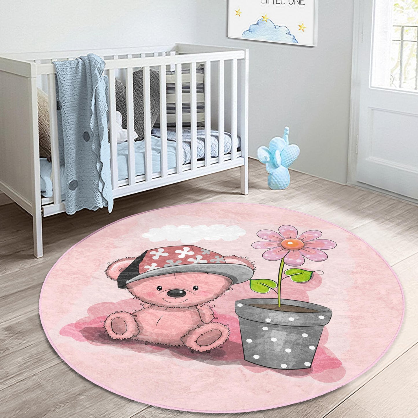 Soft and cozy rug adorned with a cute pink bear motif for children's rooms.